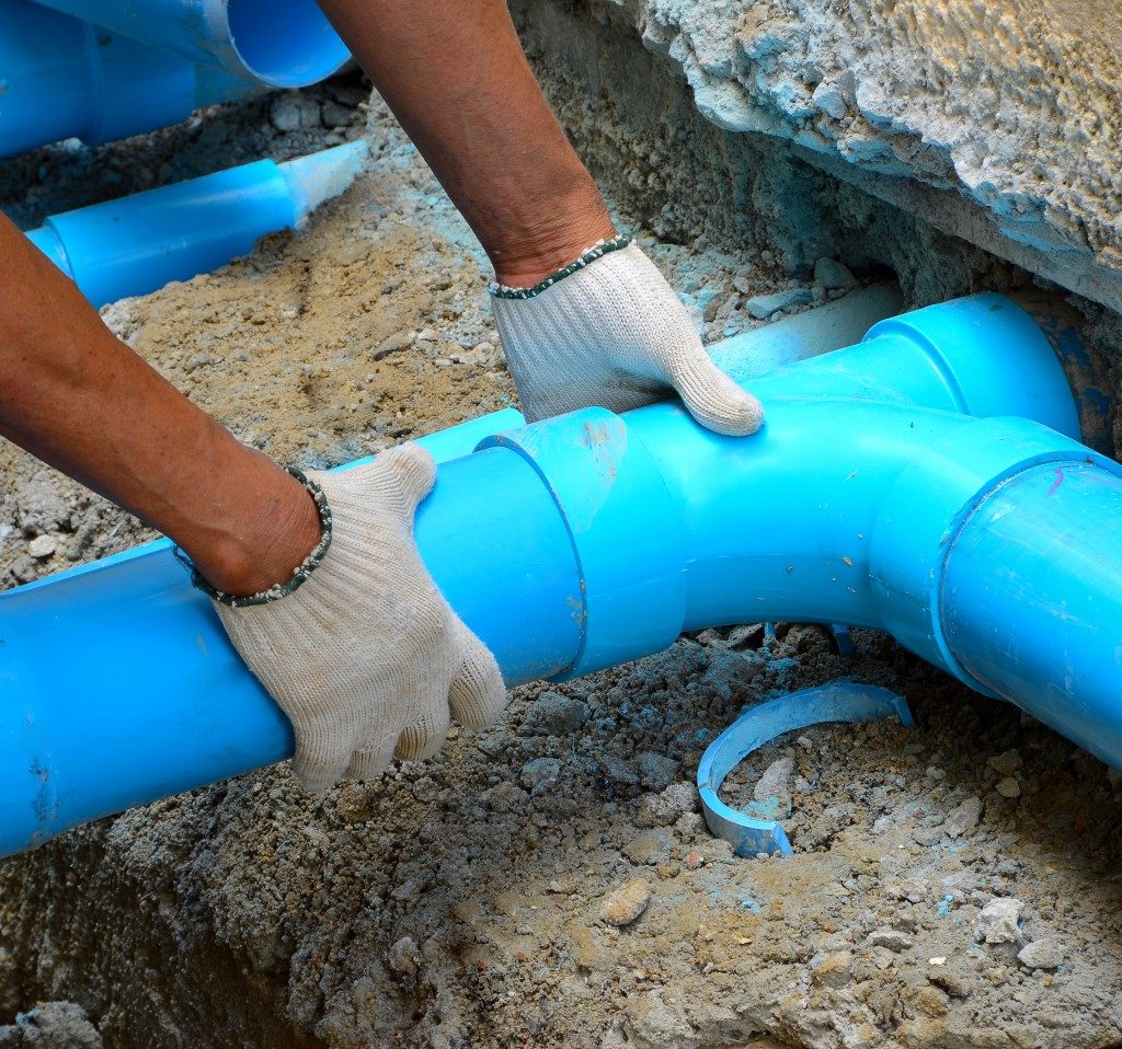 Blue pipe being fixed