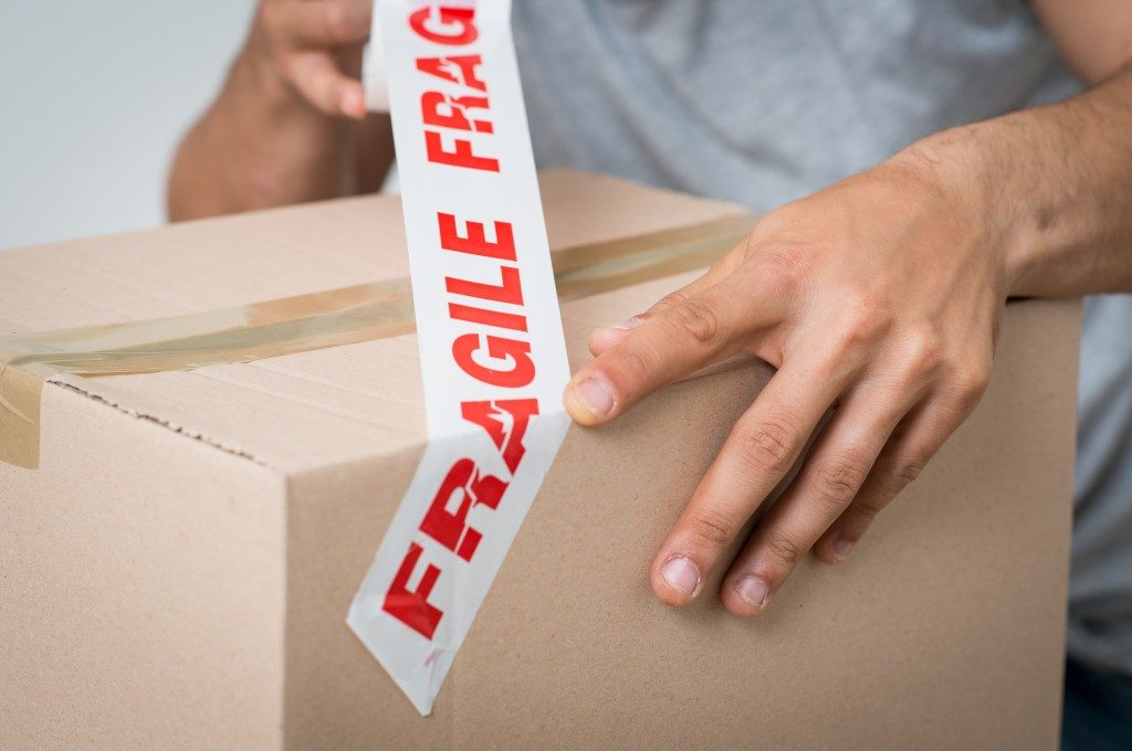 Labeling boxes with Fragile tape